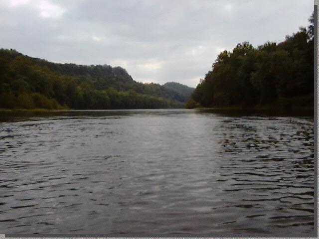 Johncanoe moving upriver on a cloudy day