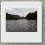 Johncanoe moves upriver on a cloudy day